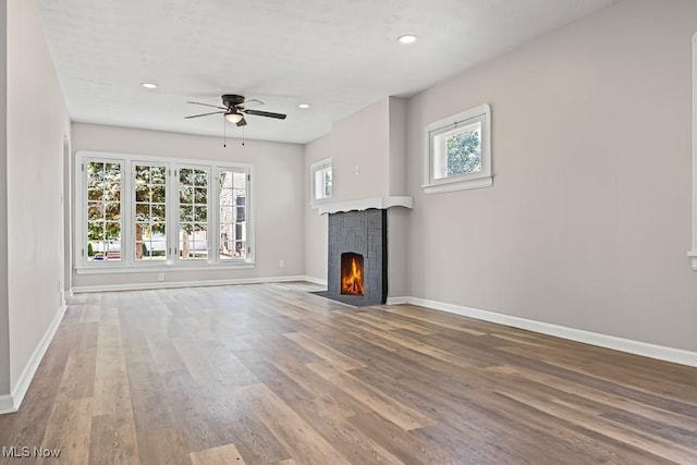 5902 Vandalia Ave, Cleveland, OH 44144 - unfurnished living room with ceiling fan, plenty of natural light, wood finished floors, recessed lighting, and a fireplace