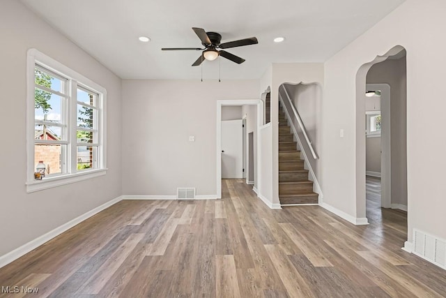 5902 Vandalia Ave, Cleveland, OH 44144 - unfurnished living room with ceiling fan, light wood finished floors, stairway, arched walkways, and recessed lighting