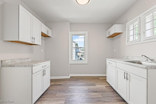 5902 Vandalia Ave, Cleveland, OH 44144 - kitchen featuring plenty of natural light, light wood-style floors, white cabinetry, and light countertops