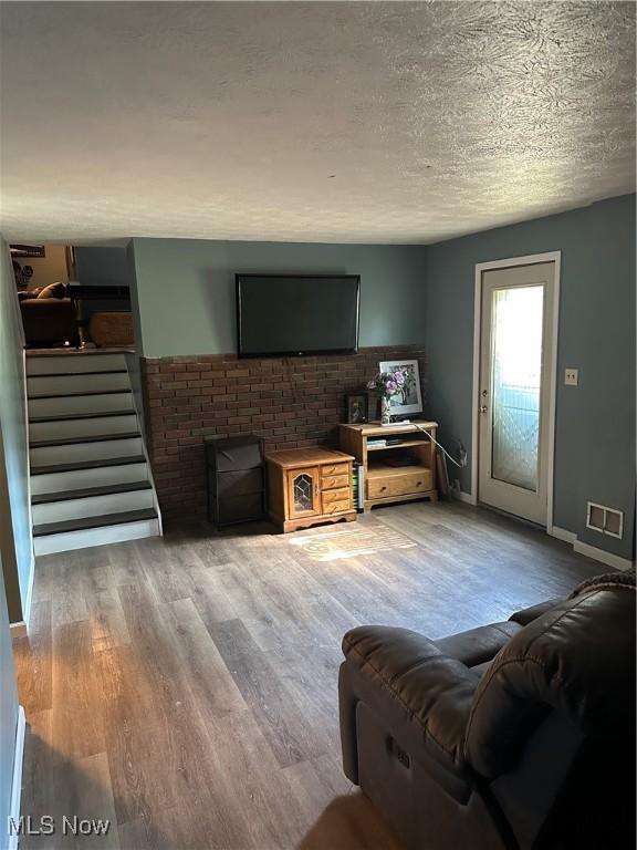 3123 S Duck Creek Rd, North Jackson, OH 44451 - living area with stairway, light wood-style floors, and a textured ceiling
