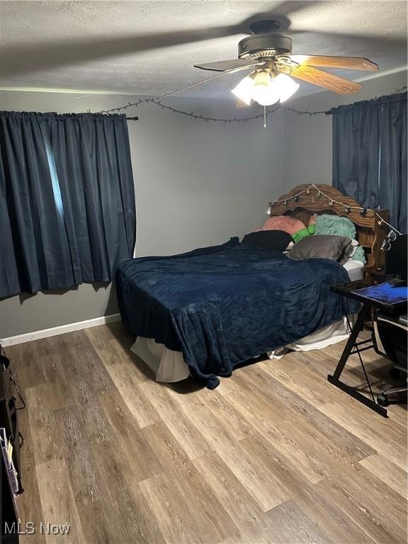 3123 S Duck Creek Rd, North Jackson, OH 44451 - bedroom featuring wood finished floors, a textured ceiling, ceiling fan, and billiards table