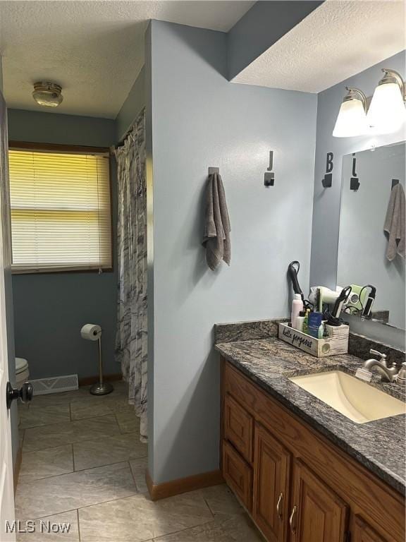 3123 S Duck Creek Rd, North Jackson, OH 44451 - full bathroom with vanity, a textured ceiling, and tile patterned flooring