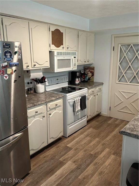 3123 S Duck Creek Rd, North Jackson, OH 44451 - kitchen with white appliances, dark wood finished floors, and white cabinets