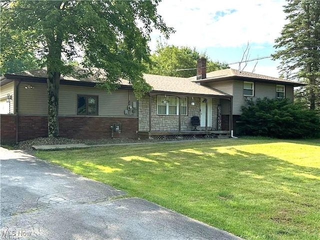 3123 S Duck Creek Rd, North Jackson, OH 44451 - tri-level home featuring covered porch, a front yard, a chimney, and brick siding
