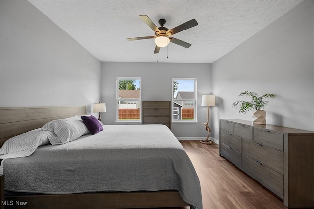 13176 Barrington Dr, Grafton, OH 44044 - bedroom featuring wood finished floors, ceiling fan, and a textured ceiling