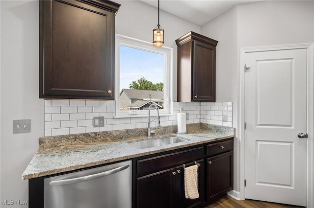13176 Barrington Dr, Grafton, OH 44044 - kitchen with dishwasher, decorative backsplash, dark brown cabinetry, light stone counters, and decorative light fixtures