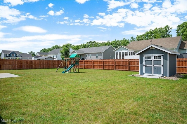 13176 Barrington Dr, Grafton, OH 44044 - fenced backyard with a playground, a storage unit, and a residential view