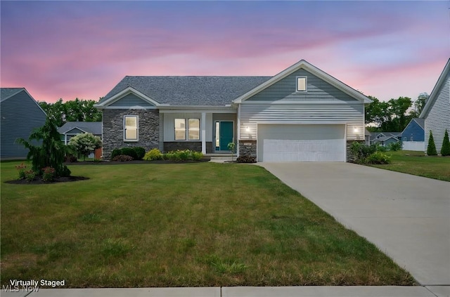 13176 Barrington Dr, Grafton, OH 44044 - view of front of property with a lawn, driveway, stone siding, and a garage