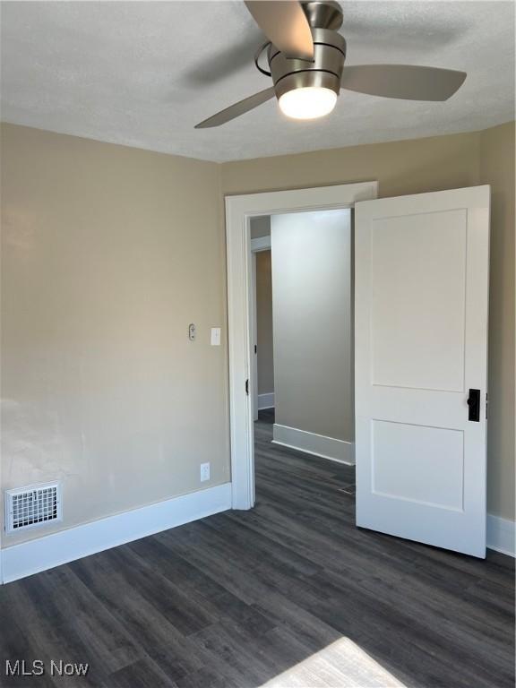 1820 E 47th St, Ashtabula, OH 44004 - unfurnished room with dark wood-style flooring and ceiling fan