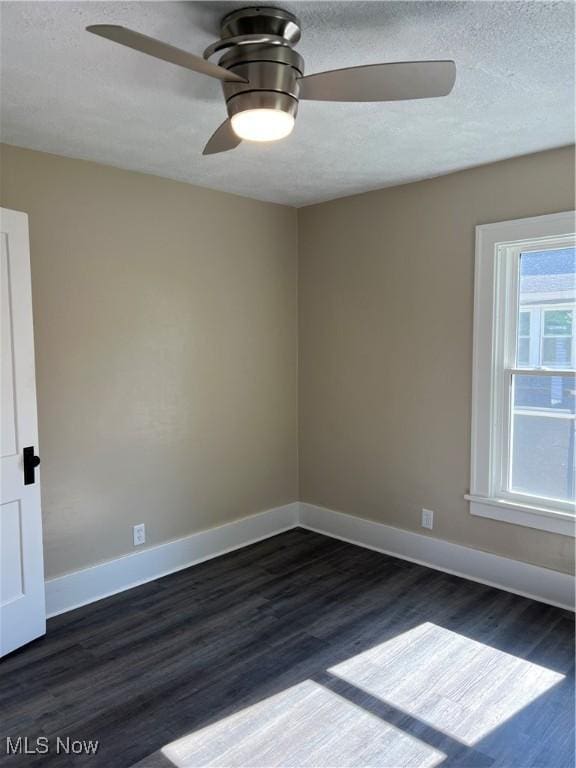 1820 E 47th St, Ashtabula, OH 44004 - spare room with a ceiling fan, dark wood-type flooring, and a textured ceiling