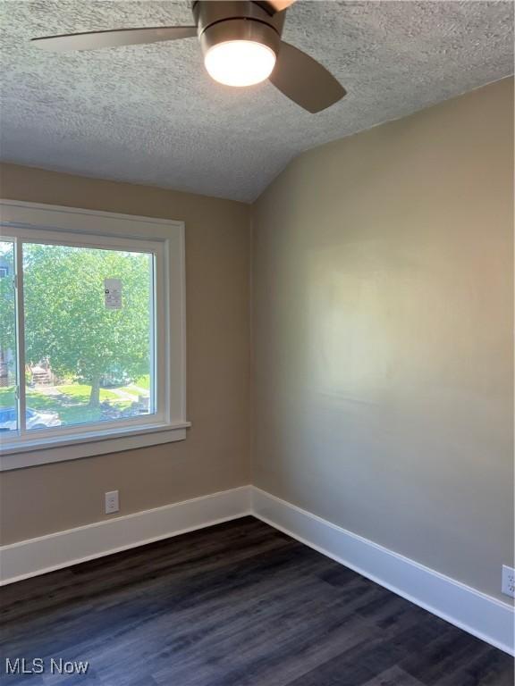 1820 E 47th St, Ashtabula, OH 44004 - spare room with a ceiling fan, dark wood-style floors, and a textured ceiling