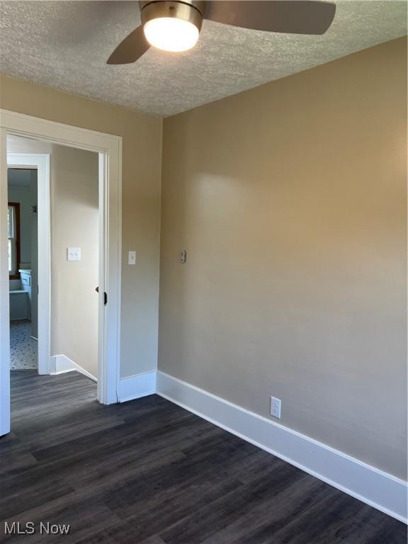 1820 E 47th St, Ashtabula, OH 44004 - empty room featuring a ceiling fan, a textured ceiling, and dark wood-type flooring