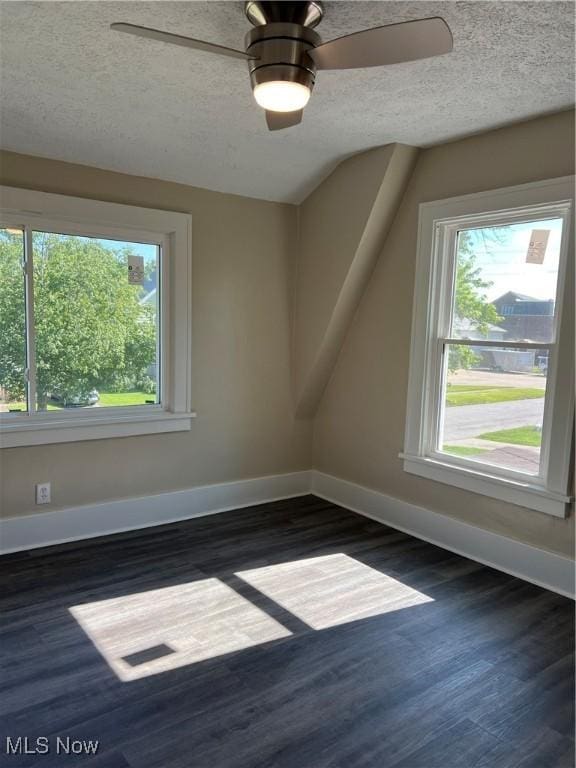 1820 E 47th St, Ashtabula, OH 44004 - additional living space featuring dark wood-type flooring, a textured ceiling, and a ceiling fan