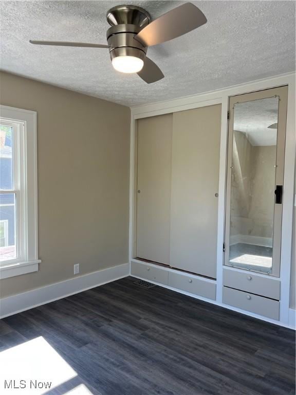 1820 E 47th St, Ashtabula, OH 44004 - unfurnished bedroom with a textured ceiling, dark wood-type flooring, ceiling fan, and a closet