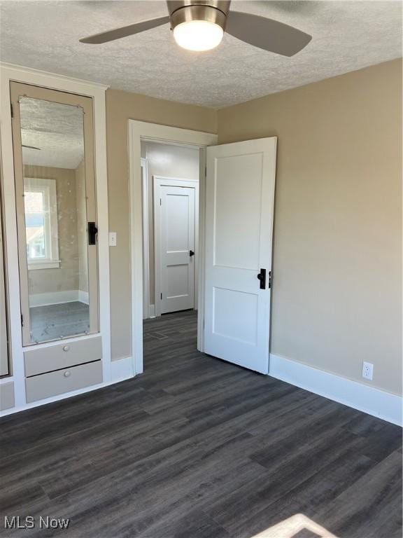 1820 E 47th St, Ashtabula, OH 44004 - empty room with ceiling fan, dark wood finished floors, and a textured ceiling