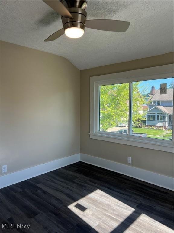 1820 E 47th St, Ashtabula, OH 44004 - empty room with a textured ceiling, dark wood finished floors, and a ceiling fan