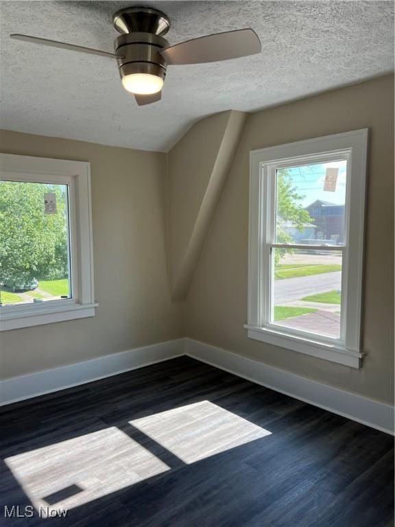 1820 E 47th St, Ashtabula, OH 44004 - bonus room with dark wood-style floors, a textured ceiling, and ceiling fan