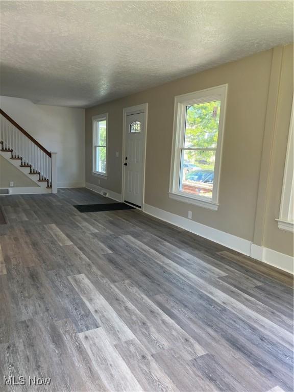 1820 E 47th St, Ashtabula, OH 44004 - entryway with a textured ceiling, wood finished floors, and stairway