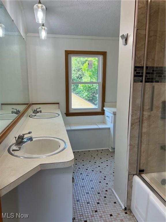 1820 E 47th St, Ashtabula, OH 44004 - bathroom featuring crown molding, double vanity, shower / bath combination with glass door, and a textured ceiling