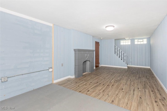 4030 Silsby Rd, University Heights, OH 44118 - basement featuring wood finished floors, stairs, and a fireplace