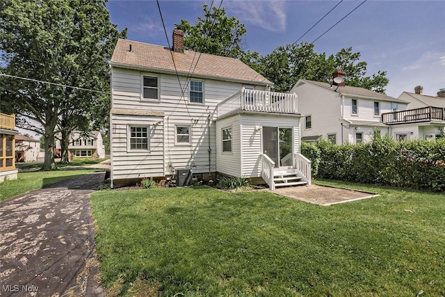 4030 Silsby Rd, University Heights, OH 44118 - back of house with a chimney, a balcony, a yard, and entry steps