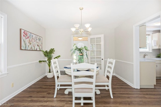 4030 Silsby Rd, University Heights, OH 44118 - dining space with a chandelier and dark wood-style floors