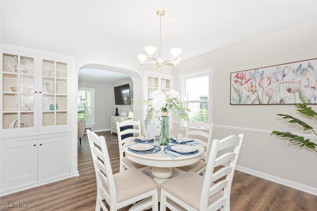 4030 Silsby Rd, University Heights, OH 44118 - dining room featuring arched walkways, wood finished floors, and a chandelier