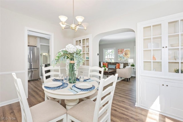 4030 Silsby Rd, University Heights, OH 44118 - dining area with arched walkways, light wood-type flooring, and a chandelier