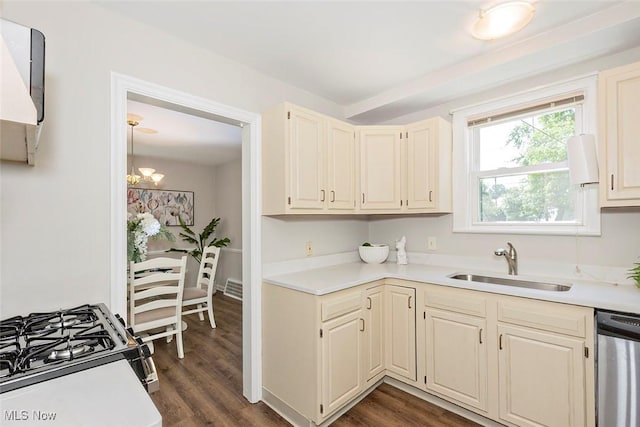 4030 Silsby Rd, University Heights, OH 44118 - kitchen with dishwasher, light countertops, gas range, dark wood finished floors, and a chandelier