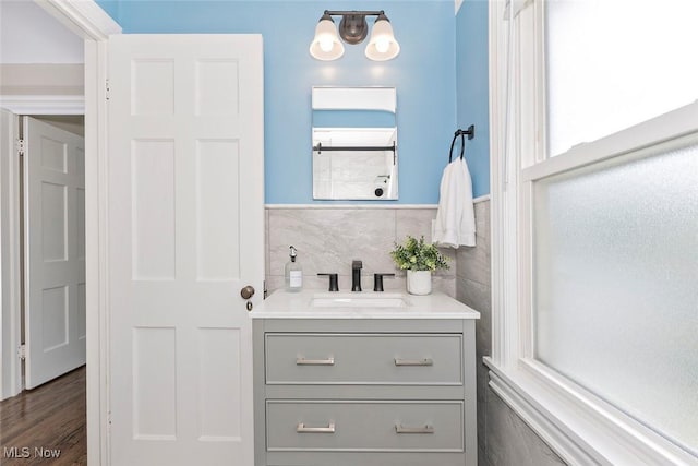 4030 Silsby Rd, University Heights, OH 44118 - bathroom with vanity, tile walls, a wainscoted wall, and a chandelier