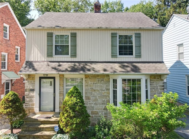 3622 Northcliffe Rd, University Heights, OH 44118 - view of front of property featuring stone siding, a chimney, roof with shingles, and board and batten siding