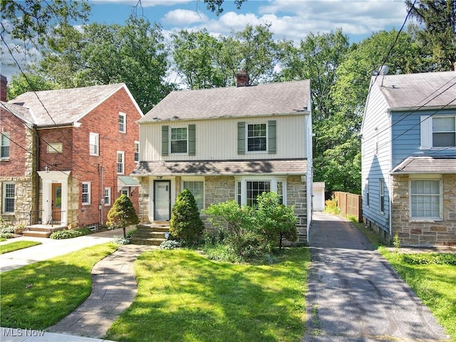 3622 Northcliffe Rd, University Heights, OH 44118 - view of front facade with stone siding, a chimney, and roof with shingles