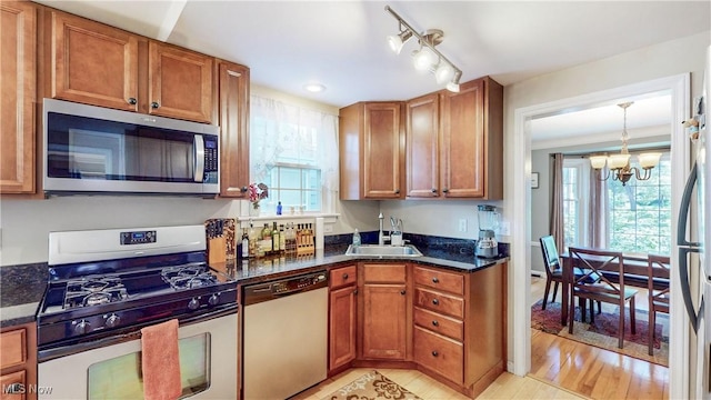 3622 Northcliffe Rd, University Heights, OH 44118 - kitchen with stainless steel appliances, a chandelier, brown cabinets, dark stone countertops, and recessed lighting