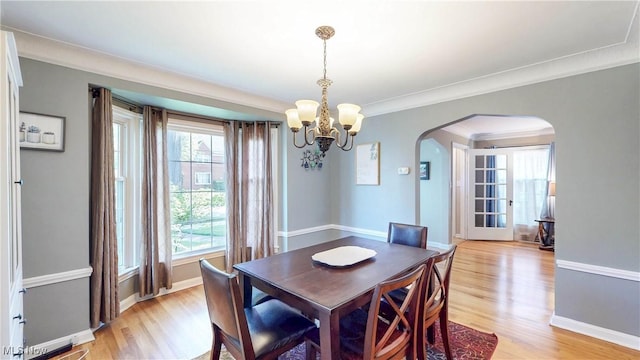 3622 Northcliffe Rd, University Heights, OH 44118 - dining area featuring arched walkways, light wood-type flooring, a chandelier, and ornamental molding
