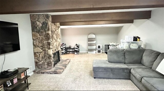 7135 N Holmes Pl, Concord, OH 44077 - carpeted living area featuring beamed ceiling and a stone fireplace
