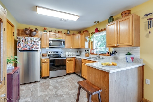 2207 Robinhood Dr, Wooster, OH 44691 - kitchen featuring stainless steel appliances, light countertops, backsplash, and a peninsula