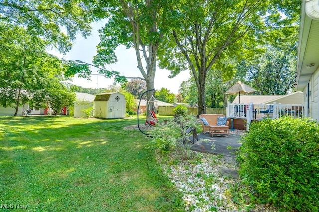 2207 Robinhood Dr, Wooster, OH 44691 - view of yard featuring a storage unit and a patio area
