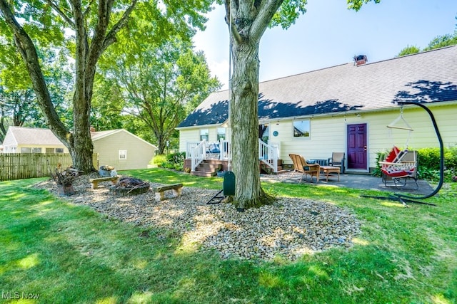 2207 Robinhood Dr, Wooster, OH 44691 - back of property with a fire pit, a deck, a patio area, and stairway