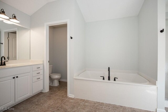 31008 Logan Ct, Westlake, OH 44145 - bathroom featuring a garden tub, vanity, and lofted ceiling