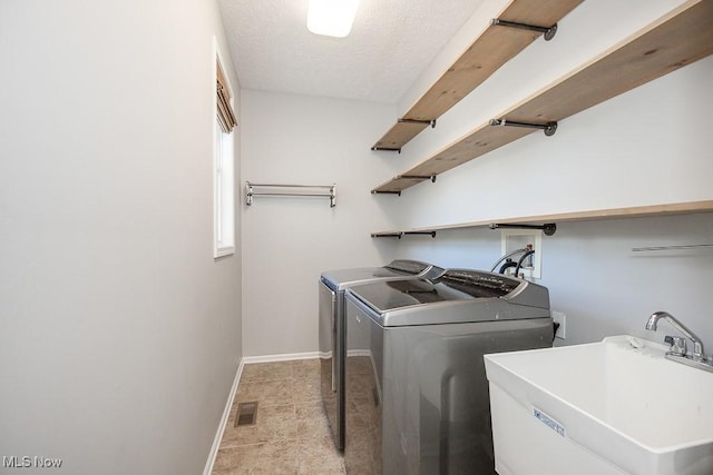 31008 Logan Ct, Westlake, OH 44145 - washroom featuring washer and clothes dryer and a textured ceiling