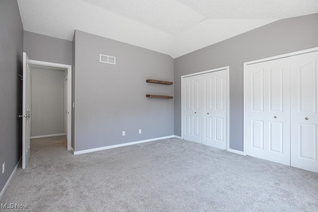 31008 Logan Ct, Westlake, OH 44145 - unfurnished bedroom with multiple closets, carpet flooring, and vaulted ceiling