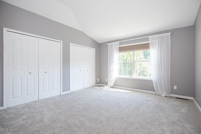 31008 Logan Ct, Westlake, OH 44145 - unfurnished bedroom featuring lofted ceiling, two closets, and carpet floors