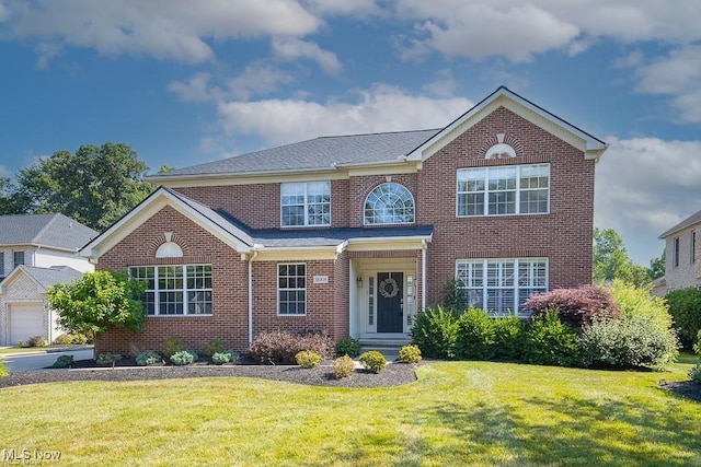 31008 Logan Ct, Westlake, OH 44145 - view of front facade with brick siding and a front yard