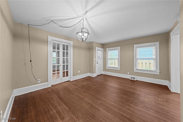 2905 Jay Ave, Cleveland, OH 44113 - unfurnished dining area with dark wood-style floors and a chandelier