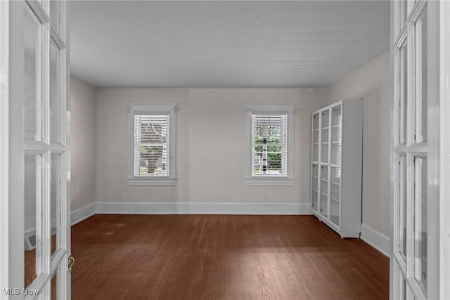 2905 Jay Ave, Cleveland, OH 44113 - unfurnished bedroom featuring dark wood-style flooring, multiple windows, and french doors