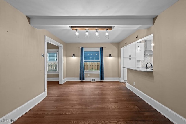 2905 Jay Ave, Cleveland, OH 44113 - unfurnished dining area with dark wood-style flooring and beam ceiling