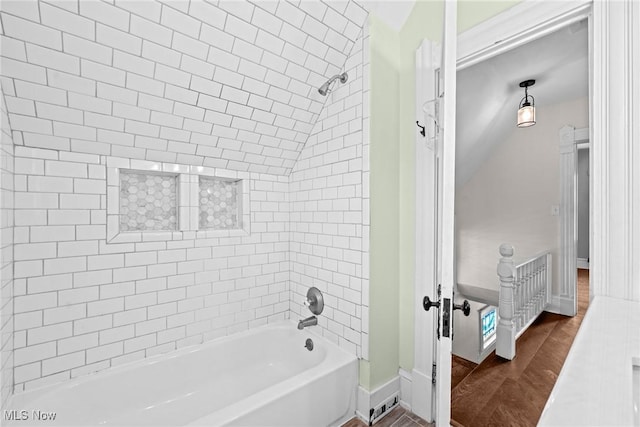 2905 Jay Ave, Cleveland, OH 44113 - bathroom with wood finished floors, bathtub / shower combination, and lofted ceiling