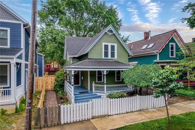 2905 Jay Ave, Cleveland, OH 44113 - victorian home with a porch, a fenced front yard, and roof with shingles