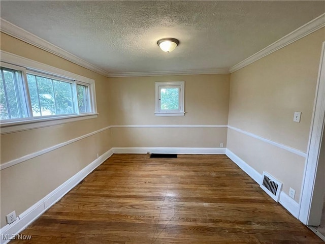 918 Silvercrest Ave, Akron, OH 44314 - spare room with a textured ceiling, wood finished floors, and ornamental molding
