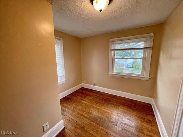 918 Silvercrest Ave, Akron, OH 44314 - empty room with hardwood / wood-style floors and a textured ceiling